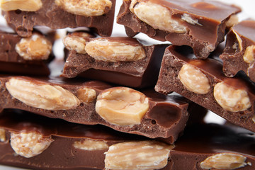 pieces of chocolate with nuts, close-up delicacy