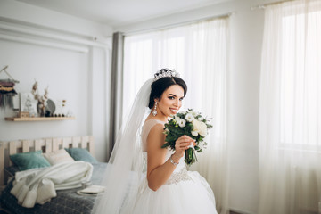 Pretty young bride with wedding bouquet