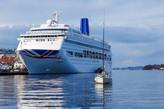 Norway cruise ship and small boat at the port ready to sail