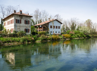 Fototapeta na wymiar farm houses on the waterway (naviglio grande) near Milan,italy