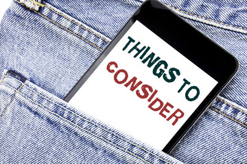 Handwriting Announcement text showing Things To Consider. Business concept for Business Knowledge Written phone mobile phone, cellphone placed in the man front jeans pocket.