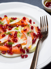 Salad with fennel, salmon and pomegranate, olive oil and pomegranate juice