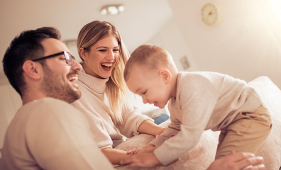 Fototapeta premium Happy young family spending time at home