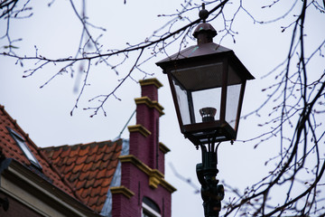 Fototapeta na wymiar Street Lantern Old Houses Streets Haarlem City Colored Holland Stone Bricks
