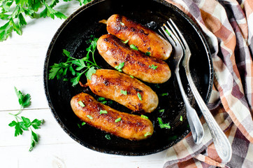 Homemade sausages from turkey (chicken) fried in a frying pan
