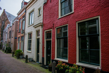 Fototapeta na wymiar Red Old Houses Streets Haarlem City Colored Holland Stone Bricks