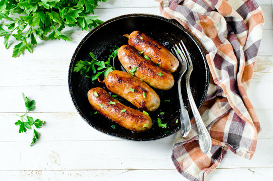 Homemade sausages from turkey (chicken) fried in a frying pan