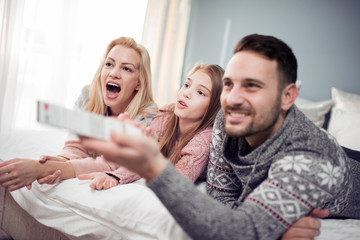 Young family watching television together