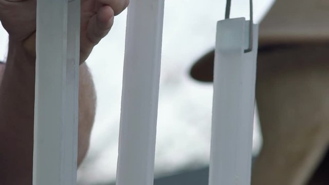 Close-up, The Musician's Fingers Extract Sound from Hanging Glass Plates