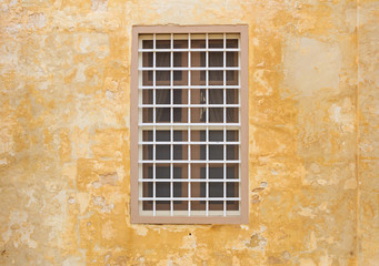 Malta, Mdina. Window on a yellow wall in the old medieval city