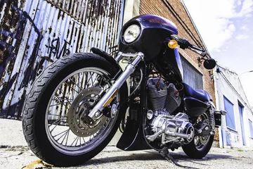 Close-up custom motor bike holds on a vintage industrial street. Outdoor portrait and urban lifestyle