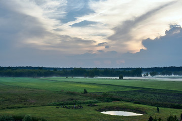 Village landscape with streaks of mist in Poland.