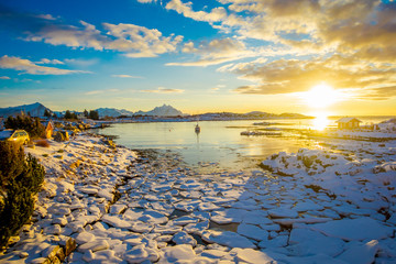 Amazing sunset view with small and medium pieces of Ice left behind during a low tide on a frozen...