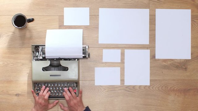 Book writing by the window with a vintage typewriter. 4K video colors and black and white