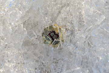 Physical golden bitcoin coin on ice