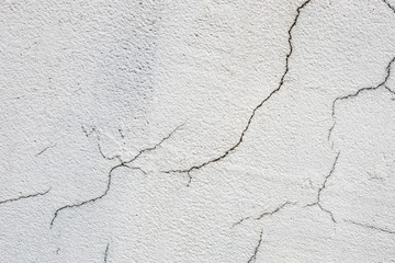 Texture of white dirty cracked wall. Small straight cracks. Direct fracture on painted surface. Cells fissure