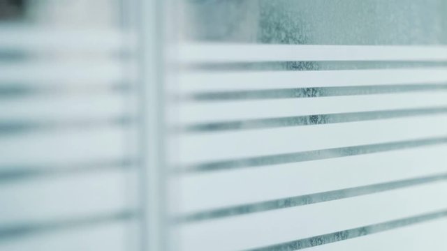 Male Figure Peering Through Window