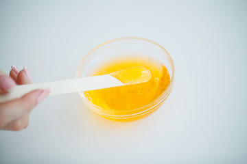 Wax and stick for depilation on white background top view