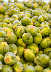 Fototapeta na wymiar Heap of raw brussels sprouts in a pile at produce market