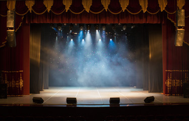 The stage of the theater illuminated by spotlights from the auditorium - obrazy, fototapety, plakaty