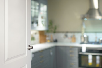 White door opened to the kitchen, blurred background