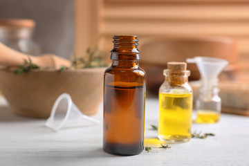 Bottles with essential oils on wooden table