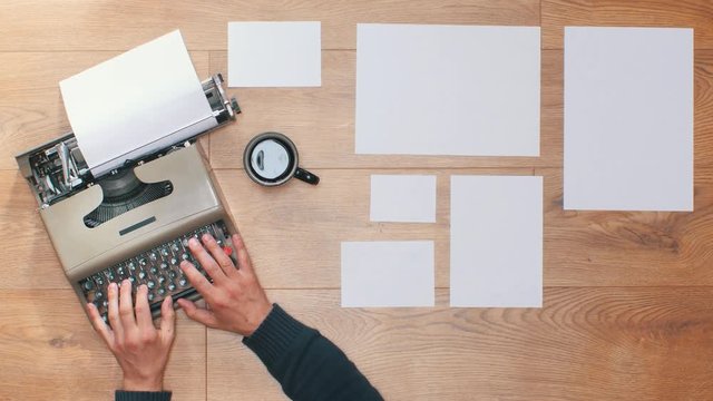 Book writing by the window with a vintage typewriter. 4K video colors and black and white