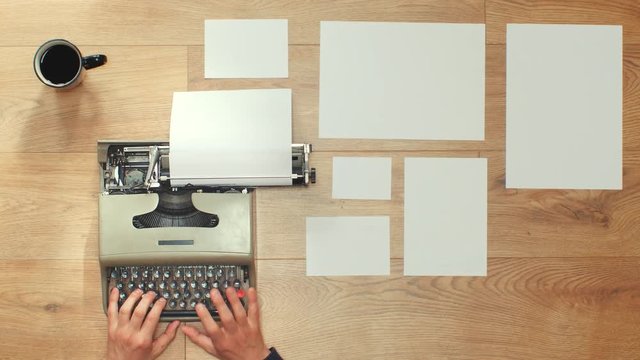 Book writing by the window with a vintage typewriter. 4K video colors and black and white