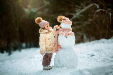 Little girl with snowman