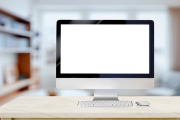 Mockup desktop computer on desk in living room background. workspace with blank screen laptop