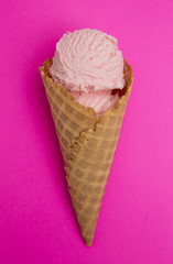 Waffle Cone with Strawberry Ice Cream on a Bright Pink Background