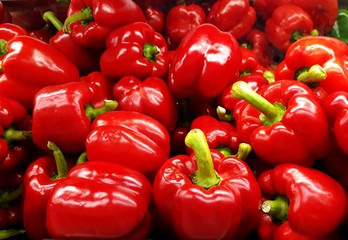 Fresh red capsicum bell peppers in a pile