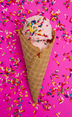Waffle Cone with Strawberry Ice Cream on a Bright Pink Background