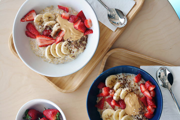 Oatmeal Breakfast with strawberry slices and banana slices, all sprinkled with bran - 200987164