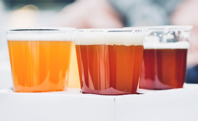 three glasses of craft beer, pale, wheat and ipa, beer flight for tester