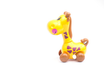 Mechanical giraffe toy. Clockwork plastic toy isolated on right with white background.
