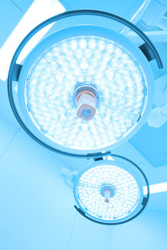 Two surgical lamps in operation room take with art lighting and blue filter