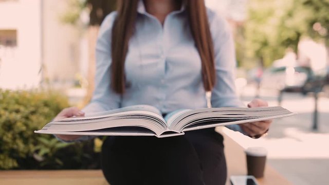 Female Student Flipping Through Book