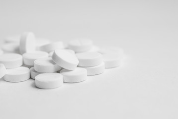 White pills isolated on white background