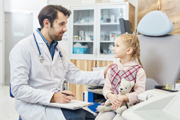 Doctor asking his little patient about her symptoms