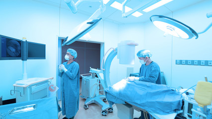 Two of veterinarian surgery in operation room take with art lighting and blue filter