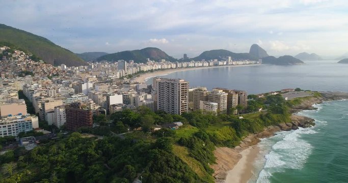 Flying backwards above Copacabana Beach in Rio de Janeiro, Brazil. Aerial view