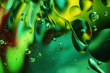 Oil bubbles in an aqueous medium on the border with a glass surface. Abstract Screen Saver.