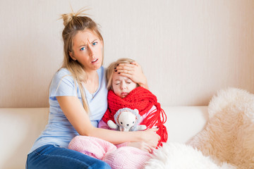 Unhappy mother with sick child at home