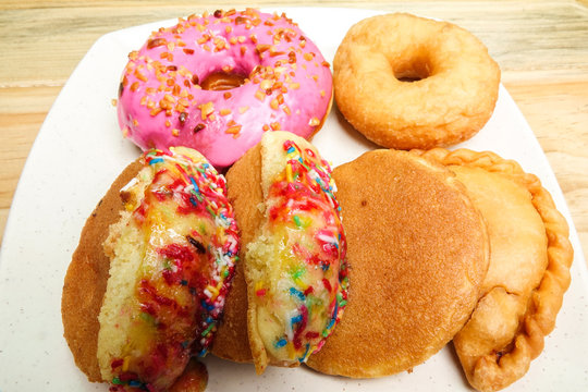 Colorful and tasty donuts on a wooden background