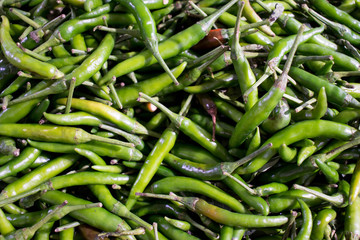 Pile of hot green Thai chili for cooking in the market for background.