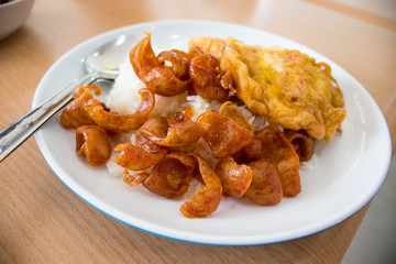 Chinese sausages and omelet topping on rice.