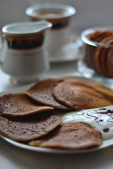 Banana-rice pancakes poured with sour cream and syrup for tea ceremony