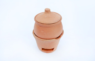 Thai handmade clay earthenware cooking pot with stove made from soil isolated on white background.
