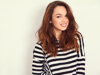 Fototapeta premium Portrait of young beautiful brunette woman girl model with nude makeup in summer hipster clothes posing near wall. Going crazy